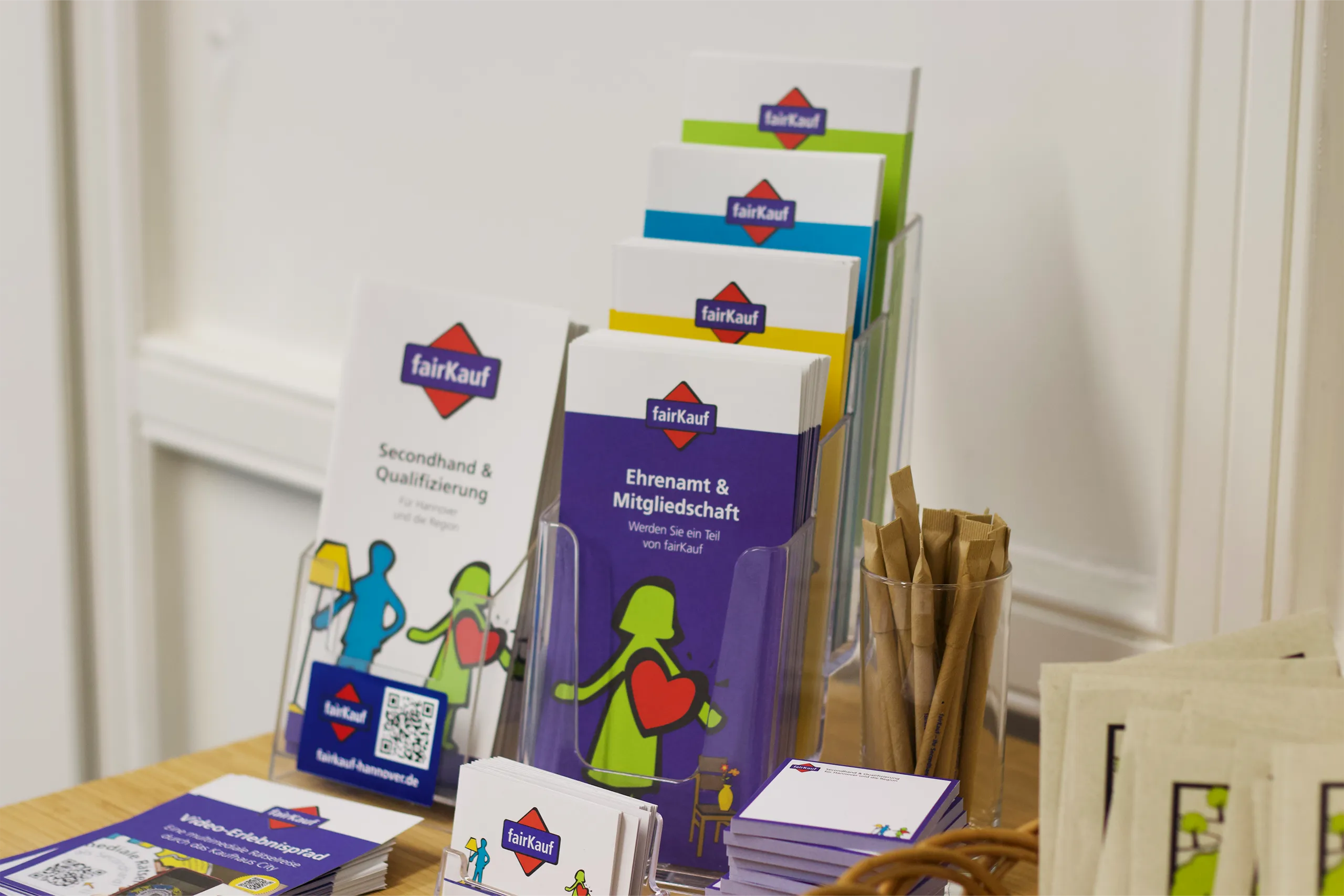 fairKauf-Infoständer mit bunten Flyern zu Ehrenamt, Qualifizierung und Spenden.